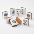 Woodgrain American Mahjong acrylic tiles angled studio shot showing layered edges