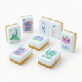 Yellow American Mahjong acrylic tiles angled studio shot showing layered edges